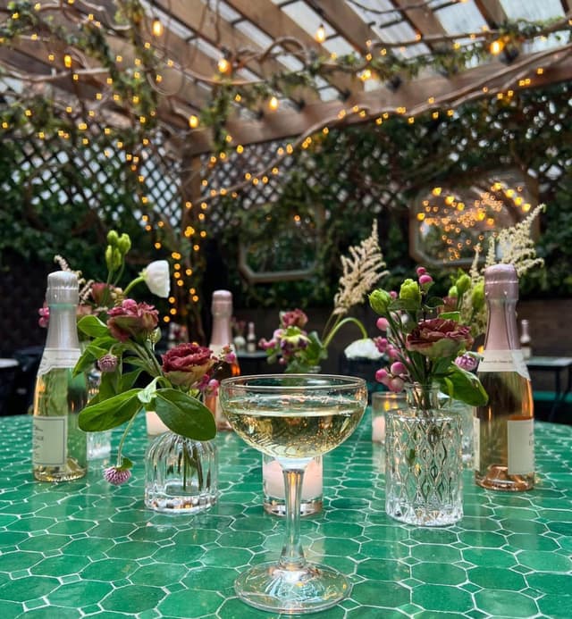 Cocktails and flowers on a table in the Secret Garden