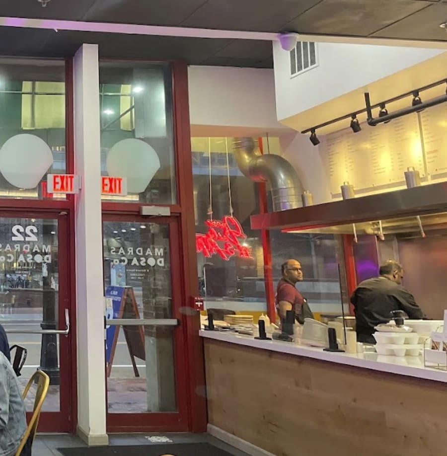 Cooks at the open kitchen counter at Madras Dosa Co Harvard Square