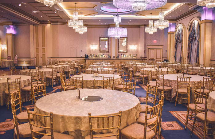 Bright event hall set with round tables for a school function