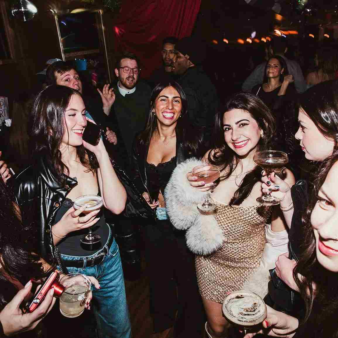 Guests celebrating with cocktails at a crowded party