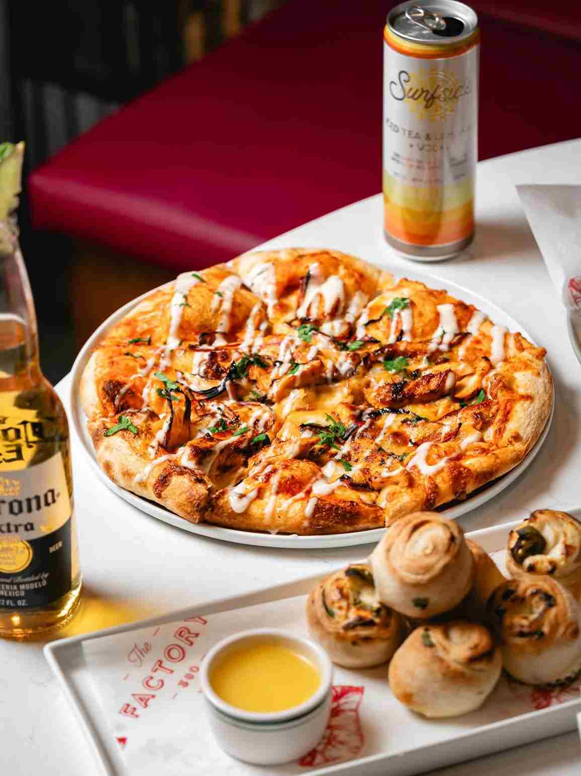 Factory 380 pizza and garlic knots with a beer and canned cocktail