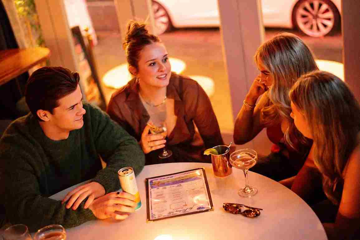 Friends sharing cocktails around a table